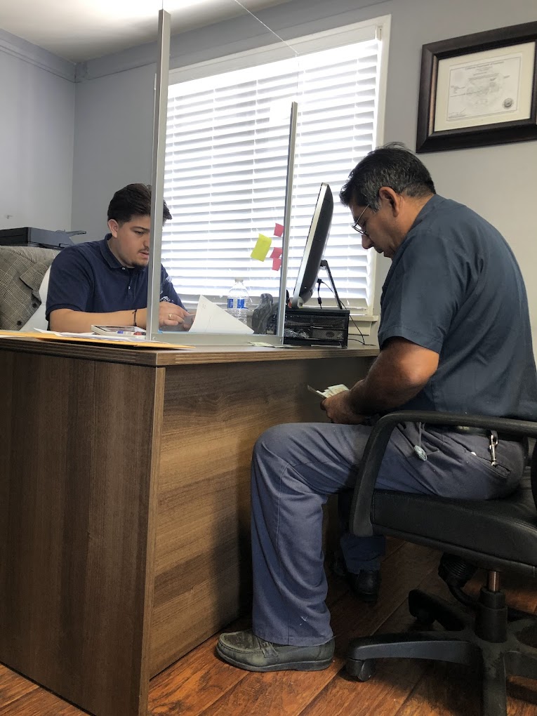 NITRA Agency staff helping customer with DMV registration and insurance paperwork in Hawaiian Gardens