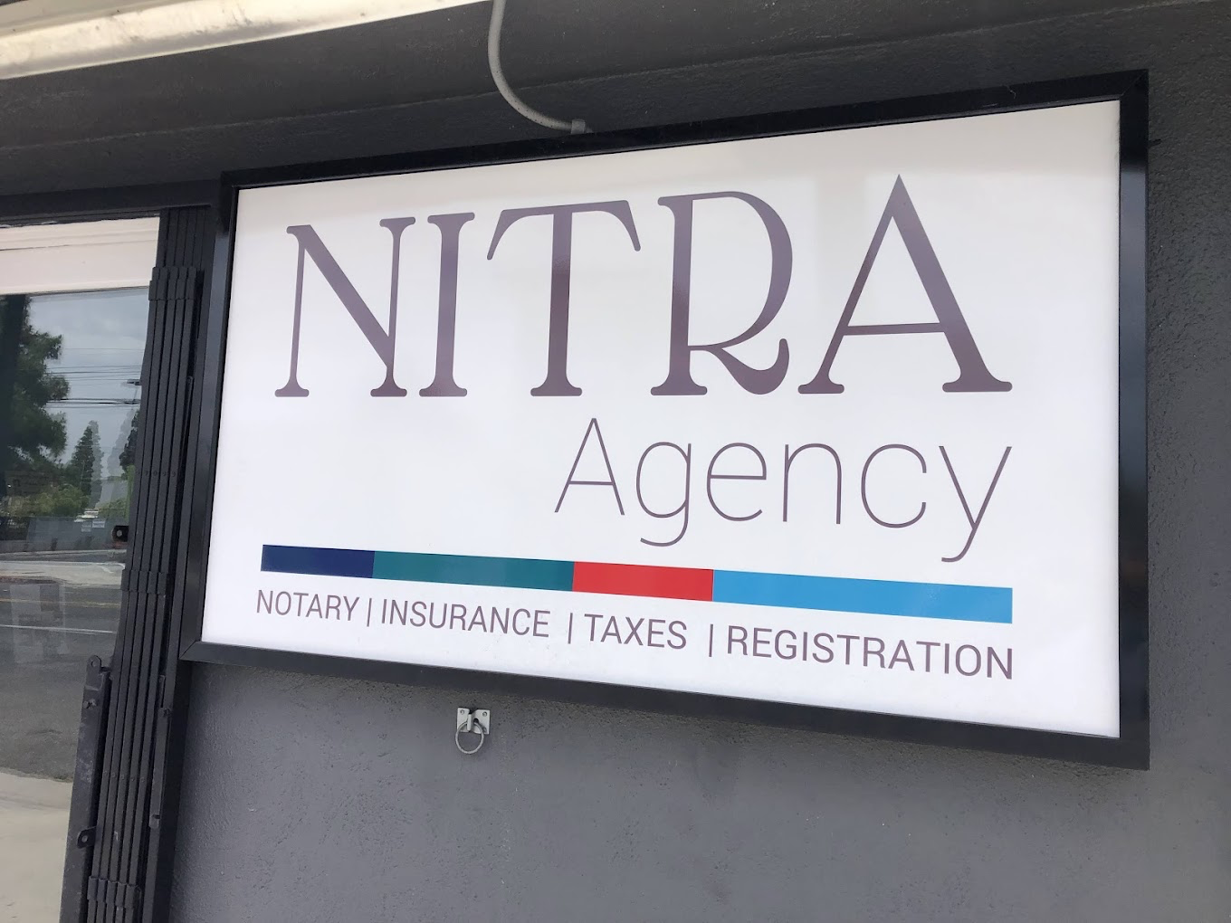 NITRA Agency professional signage showing notary, insurance, taxes and registration services